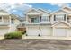 Two-story townhome with attached garage and balcony at 505 Ashley Dr, Dunedin, FL 34698