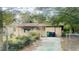 Tan brick ranch home with driveway and yard at 6405 Riverbend Cir, Tampa, FL 33610