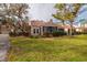 Landscaped backyard with lush lawn and view of neighboring homes at 661 Segovia Ne Ct, St Petersburg, FL 33703