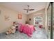 Cozy bedroom with tile floors and large window at 661 Segovia Ne Ct, St Petersburg, FL 33703