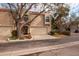 Tan two-story townhome with attached garage and lush landscaping at 661 Segovia Ne Ct, St Petersburg, FL 33703