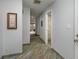 A hallway with light walls and wood-look tile floors at 661 Segovia Ne Ct, St Petersburg, FL 33703