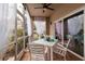 Screened patio with white furniture and sheer curtains at 661 Segovia Ne Ct, St Petersburg, FL 33703