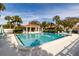 Community pool with patio tables and umbrellas at 661 Segovia Ne Ct, St Petersburg, FL 33703
