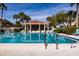 Community pool with patio tables and umbrellas at 661 Segovia Ne Ct, St Petersburg, FL 33703