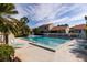 Community pool with lounge chairs and patio tables at 661 Segovia Ne Ct, St Petersburg, FL 33703