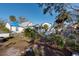 Large backyard with a shed, some garden beds, and a blue tarp on the roof at 7408 S Elliott St, Tampa, FL 33616