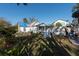 Backyard view, showing a white house, shed, and fenced-in area at 7408 S Elliott St, Tampa, FL 33616