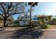 Front view of charming white house with yard at 7408 S Elliott St, Tampa, FL 33616