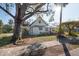 Charming white house with mature trees and a spacious yard at 7408 S Elliott St, Tampa, FL 33616