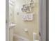 Small bathroom with pedestal sink, decorative shelving, and linen towels at 8841 Walnut Gable Ct, Riverview, FL 33578