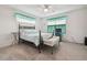 Bright bedroom with ceiling fan, comfortable bed and window at 8841 Walnut Gable Ct, Riverview, FL 33578