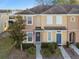 Townhouse exterior with landscaping and American flag at 8841 Walnut Gable Ct, Riverview, FL 33578
