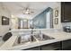 Kitchen features double sink, granite counters, and view into living room at 8841 Walnut Gable Ct, Riverview, FL 33578