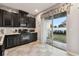 Bright kitchen with dark cabinets and sliding glass door to patio at 8841 Walnut Gable Ct, Riverview, FL 33578