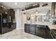 Spacious kitchen with dark cabinetry, stainless steel sink, and view of living area at 8841 Walnut Gable Ct, Riverview, FL 33578