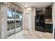 Kitchen with black appliances and sliding door leading to the backyard at 8841 Walnut Gable Ct, Riverview, FL 33578