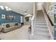 Open living area with staircase, and a view into the kitchen at 8841 Walnut Gable Ct, Riverview, FL 33578