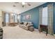 Spacious living room with a sofa, dining table and a view of the stairs at 8841 Walnut Gable Ct, Riverview, FL 33578