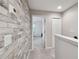 Upstairs hallway with wood-like wall and access to bedrooms at 8841 Walnut Gable Ct, Riverview, FL 33578