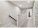 Upstairs hallway with carpeted floors and access to bedrooms at 8841 Walnut Gable Ct, Riverview, FL 33578