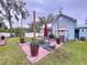 Charming backyard with patio, string lights, and a spacious lawn at 908 E Gilchrist St, Plant City, FL 33563