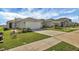 New home exterior, two-car garage, and landscaped front yard at 9383 Sandy Bluffs Cir, Parrish, FL 34219