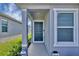 Inviting front entrance with a dark-colored door and sidelights at 9383 Sandy Bluffs Cir, Parrish, FL 34219