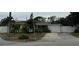 Single story home with American flag and paved driveway at 9524 Treasure Ne Ln, St Petersburg, FL 33702