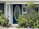 Inviting front door entry with lush landscaping at 9524 Treasure Ne Ln, St Petersburg, FL 33702