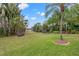 Landscaped backyard with tropical plants and grass at 10526 100Th St, Largo, FL 33773