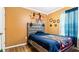 Bedroom with a full-size bed and orange walls at 12017 Gillingham Harbor Ln, Gibsonton, FL 33534