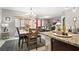 Bright dining room adjacent to kitchen, featuring a wooden table and chairs at 12017 Gillingham Harbor Ln, Gibsonton, FL 33534