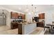 Modern kitchen with island, granite countertops, and dark wood cabinets at 12017 Gillingham Harbor Ln, Gibsonton, FL 33534