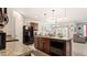 Spacious kitchen boasts an island, granite countertops, and dark wood cabinets at 12017 Gillingham Harbor Ln, Gibsonton, FL 33534