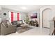Cozy living room features a gray sofa and a mounted flat-screen TV at 12017 Gillingham Harbor Ln, Gibsonton, FL 33534