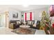 Cozy living room featuring a sectional sofa, coffee table, and Christmas tree at 12017 Gillingham Harbor Ln, Gibsonton, FL 33534