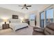 Spacious bedroom with king-size bed, large windows, and a ceiling fan at 12077 Gandy N Blvd # 344, St Petersburg, FL 33702