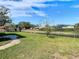 Landscaped backyard with canal view and stone patio at 1210 Lady Elaine Dr, Valrico, FL 33594