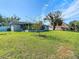 Large backyard with green grass and view of screened porch at 1210 Lady Elaine Dr, Valrico, FL 33594