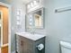 Modern bathroom boasts a gray vanity and decorative mirror at 1210 Lady Elaine Dr, Valrico, FL 33594