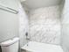 Bathroom with a bathtub and marble-tiled shower surround at 1210 Lady Elaine Dr, Valrico, FL 33594