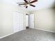 Bright bedroom with ceiling fan, carpet, and double door closet at 1210 Lady Elaine Dr, Valrico, FL 33594