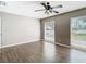 Bright bedroom featuring wood-look floors and large windows at 1210 Lady Elaine Dr, Valrico, FL 33594