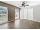 Spacious bedroom with wood-look floors and large windows at 1210 Lady Elaine Dr, Valrico, FL 33594