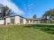 Single-story home with a blue and beige exterior, landscaped yard, and attached garage at 1210 Lady Elaine Dr, Valrico, FL 33594