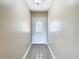 Clean hallway with tile floors and a white door at 1210 Lady Elaine Dr, Valrico, FL 33594