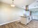 Open concept kitchen with island, white cabinets and stainless steel appliances at 1210 Lady Elaine Dr, Valrico, FL 33594