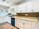 Updated kitchen with white cabinets, teal dishwasher and stainless steel appliances at 1210 Lady Elaine Dr, Valrico, FL 33594