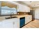Clean kitchen featuring white cabinets, a teal dishwasher, and stainless steel sink at 1210 Lady Elaine Dr, Valrico, FL 33594